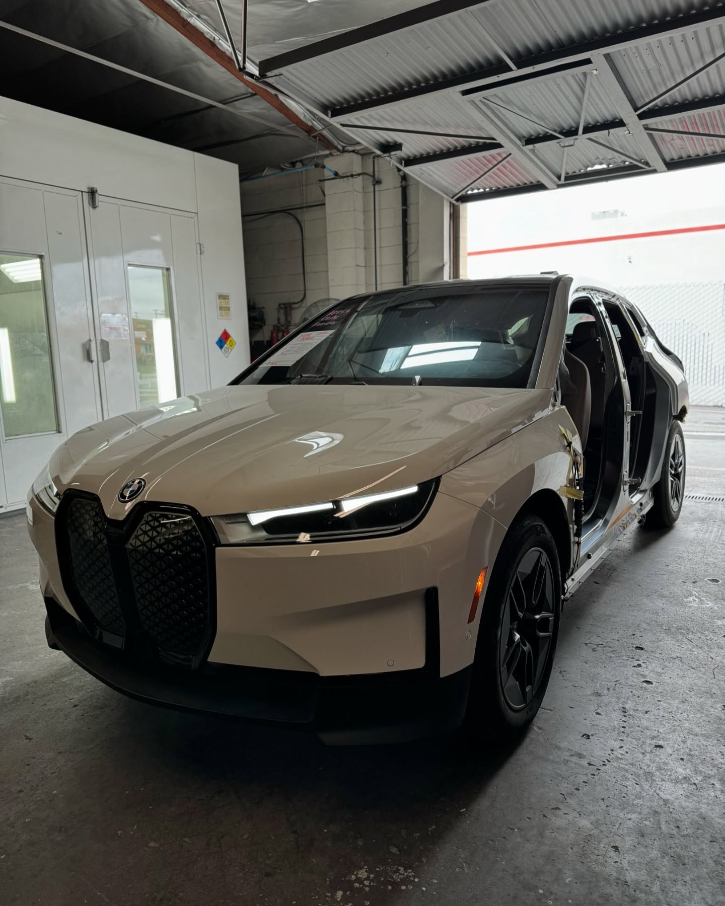 BMW iX carbon fiber uniside replacement and EV collision repair at Supreme Collision Center in Fullerton